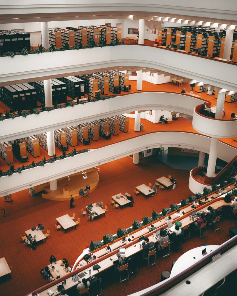 A bright, modern library interior with bookshelves and reading desks