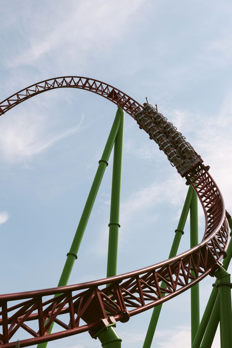 A roller coaster looping against a bright sky