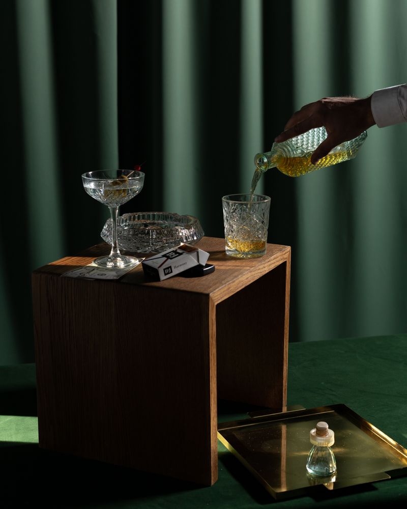 Whisky being poured into a glass in warm, retro light