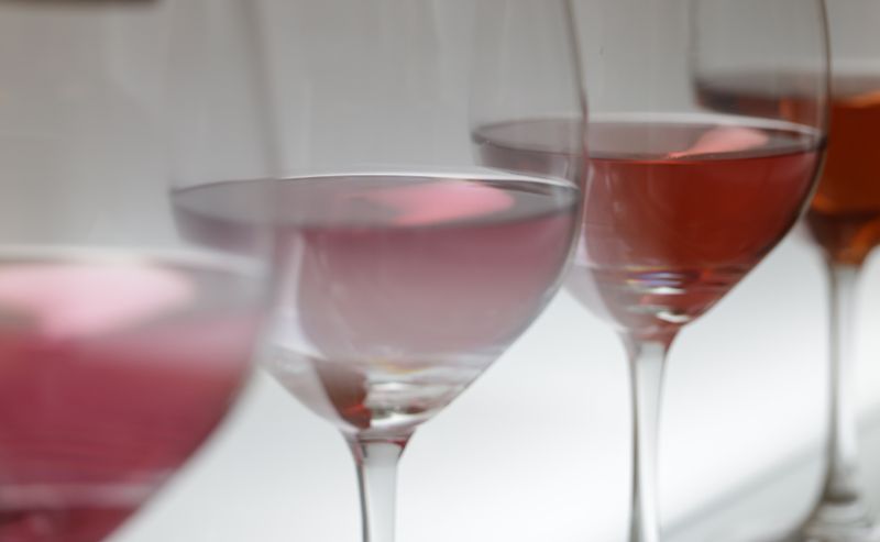 Rows of wine glasses catching soft light at a winery